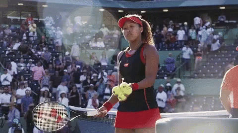 the two women are playing tennis in front of the audience