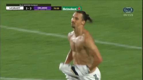 a man without a shirt is running on the field
