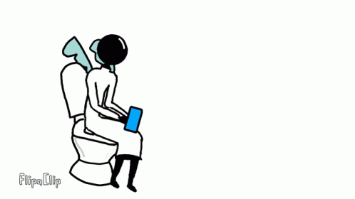 a person is sitting on a toilet with a book in his lap