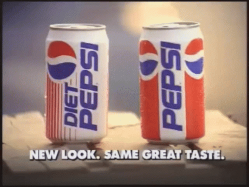 two pepsi cans sitting next to each other