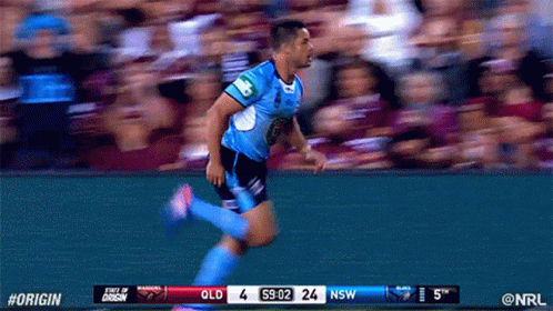 a player running towards a soccer ball and a stadium