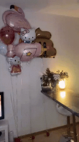 a bunch of balloons with hello kitty on them