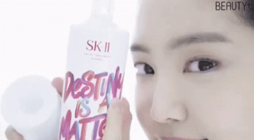 this girl is holding up an advertit for cosmetics