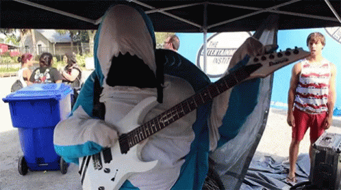 a person in a costume plays an electric guitar