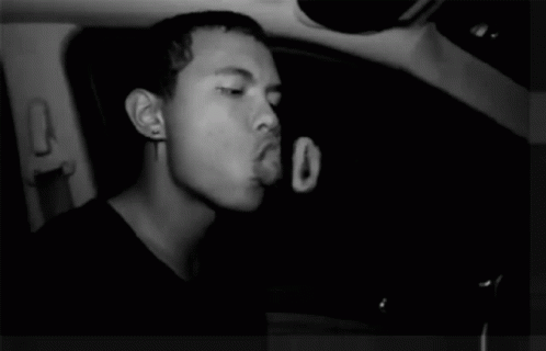 a man in a car with his eyes closed