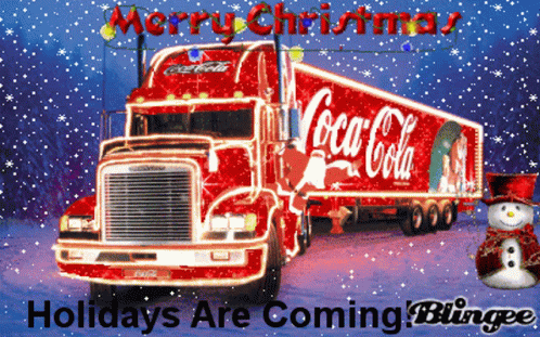 a blue coca - cola truck in front of a christmas scene