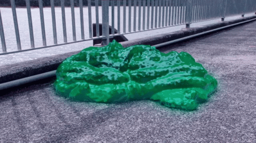 green lettuce sitting on the ground on a city sidewalk