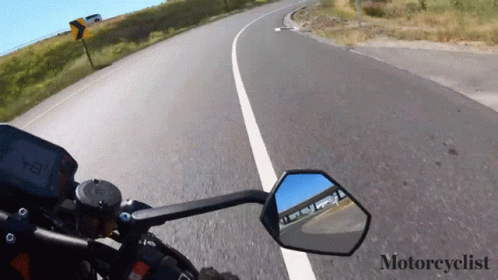 a view from the handle bar of a motorcycle going down an highway
