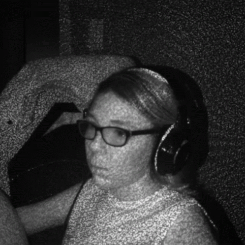 the woman in the recording room is listening to music
