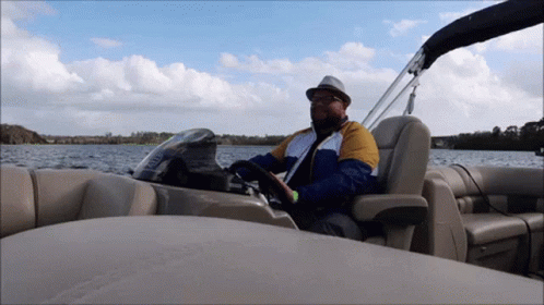 a man driving on a boat in the water