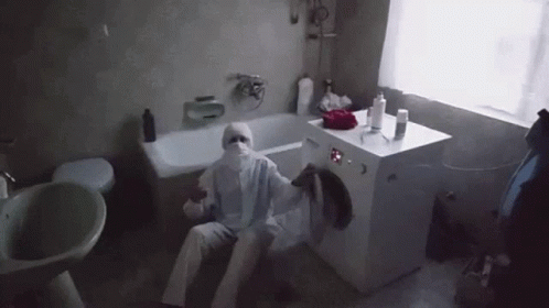 a man in a white robe in a bathroom
