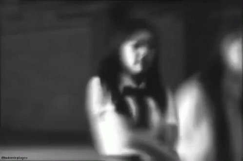 a blurry black and white po of a woman