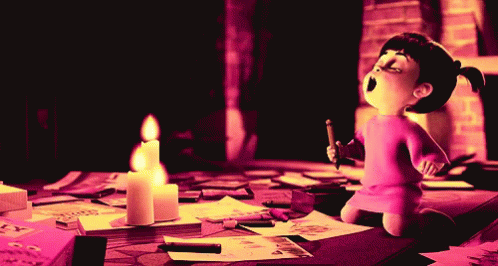 there is a figurine sitting at a table with many papers