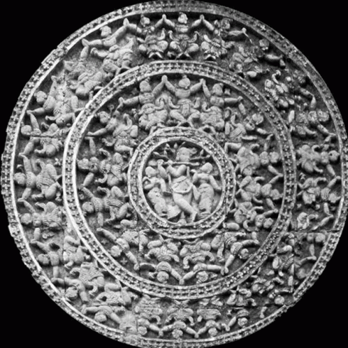a circular sculpture with multiple figures and circular design