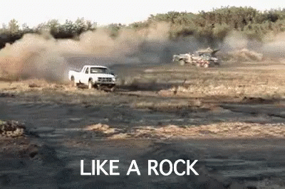 truck with dirt blowing in the background that says like a rock