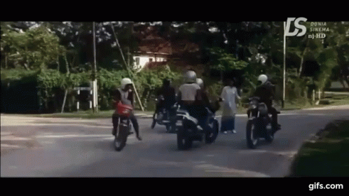 group of people on motorcycles passing each other