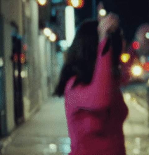 blurry image of a woman's hand on the street