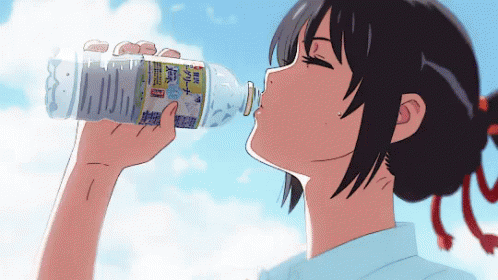 a boy drinking a bottle from a large cup
