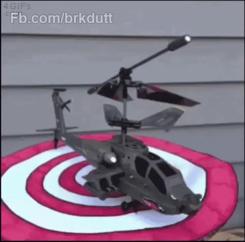 the toy helicopter is on top of a purple target