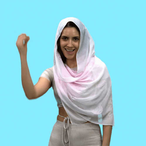a girl in a pink scarf with her hand up