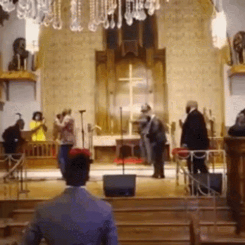 a group of people inside of a church surrounded by pews
