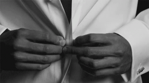 two hands holding on to a white bowtie