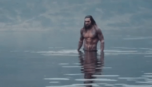 man with beard and long hair walking in the water