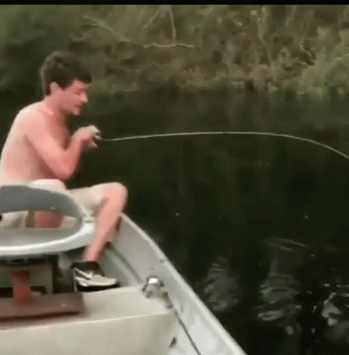 a man fishing on a boat with a fish