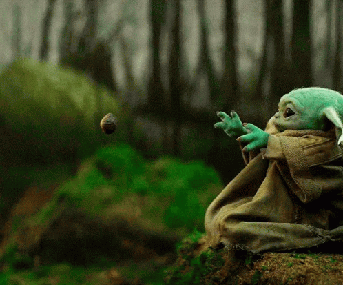 yoda sitting on a rock and throwing an object