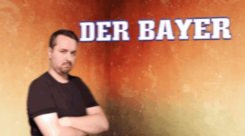 man with crossed arms standing in front of the wall and text saying der bayer