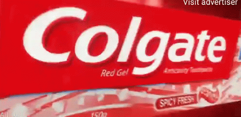 a large colgate sign mounted on the side of a building