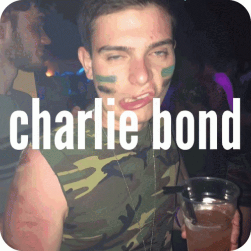 a man holding up a drink with text that says charlie bond