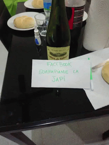 a bottle of champagne on a table with place mats