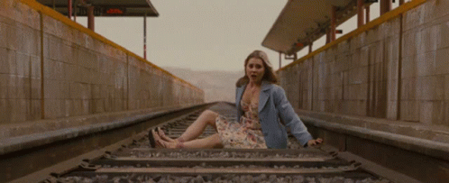 a  sitting on the end of train tracks