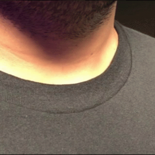 the back of a mans face has a strange looking shirt