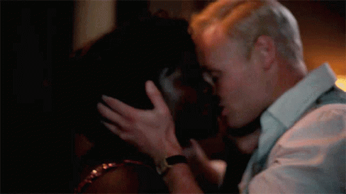 a man kissing a woman in the dark