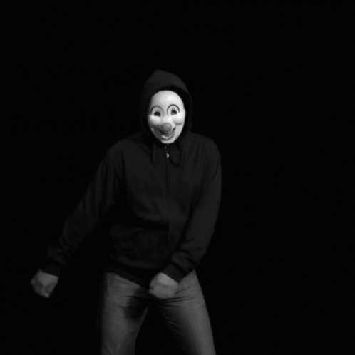 a man wearing a mask has his hands in his pocket