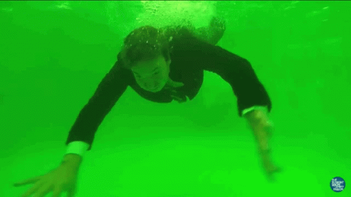 a man in a wetsuit in the middle of the water