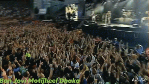 a large group of people with their hands up