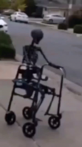an alien hing a cart on the sidewalk