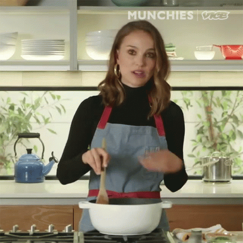 there is a woman cooking in the kitchen