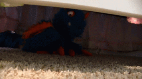 the teddy bear is under the bed cover