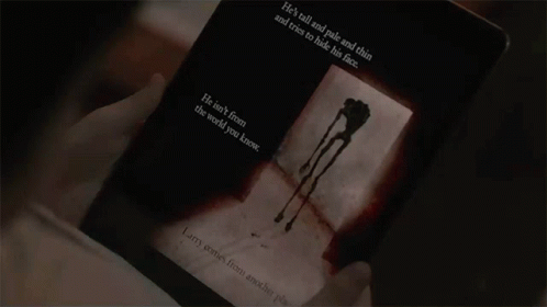 the person is reading his book'death in the dark,'a novel that he wrote
