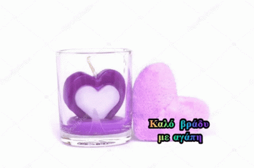 a glass filled with a purple heart in front of a white background