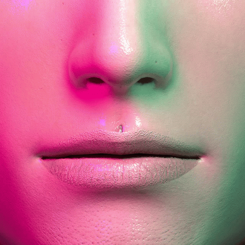 a woman's lips, purple light and white background