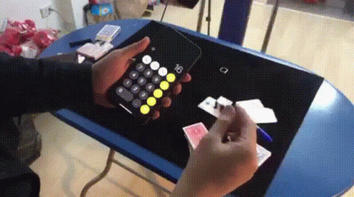a person playing with a remote control for the phone