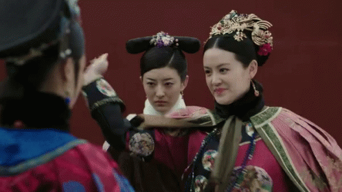 two women are dressed in elaborate clothing