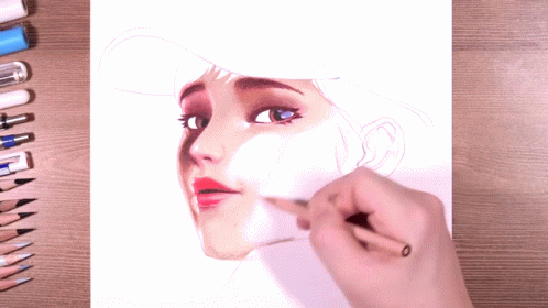 a woman is drawing on a piece of paper