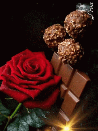 a blue rose and a piece of chocolate