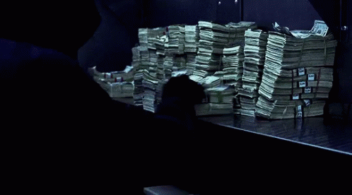 several stacks of cash sitting on top of a table